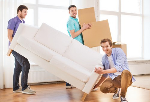 Moving team handling heavy items through a home entrance