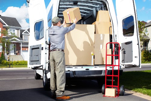Local crew removing office furniture during a commercial pickup in Hire