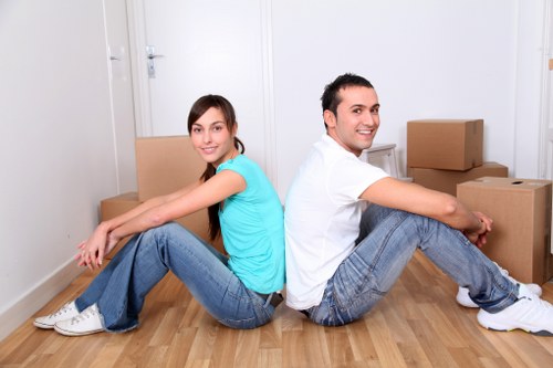 Local moving team organizing boxes in Hire