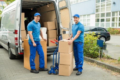 Residential movers carrying furniture in Hire