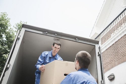Helper carrying boxes during a local man with van job in Hire